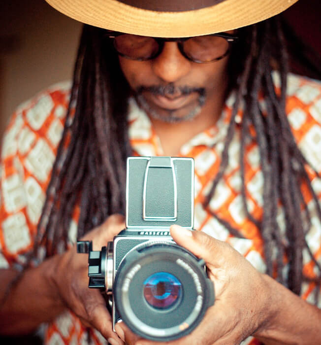 African American man holding an old time camera